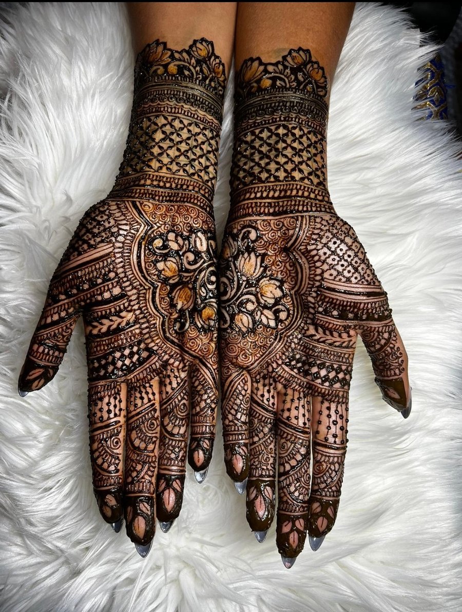 Detailed bridal mehndi hands with lotus motifs